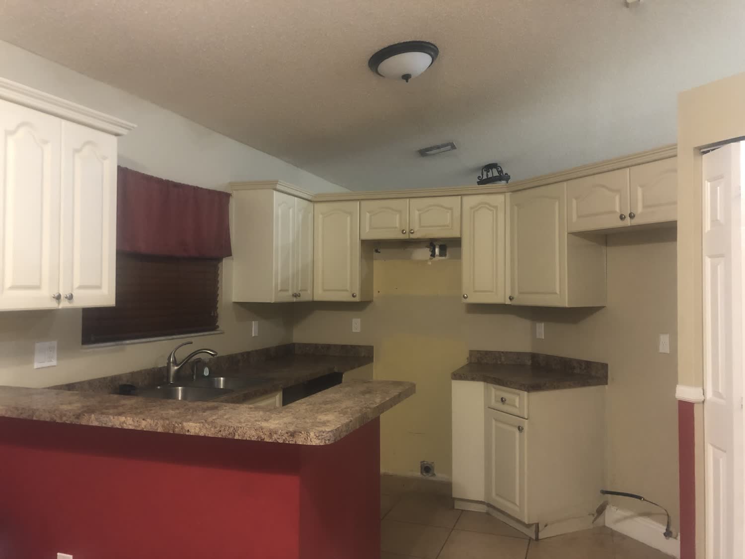 Dated dark kitchen before a whole-home gut renovation in a Country Walk Miami-Dade house