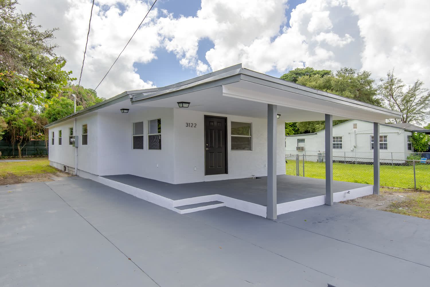 Bright renovated interior with new wood-look plank flooring in a Liberty City fix and flip project