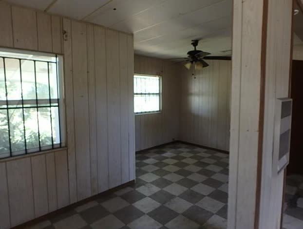 Worn interior of a Liberty City single-family house before the investor fix and flip renovation began
