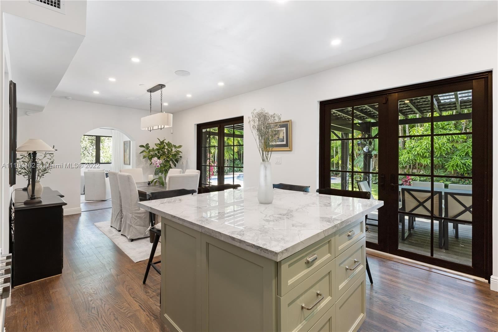 Marble island kitchen in a Miami luxury home remodel managed end to end by a licensed general contractor