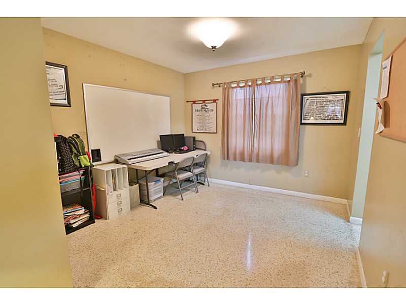 Dated interior of a Miami single-family home before renovation, flooring and finishes still in place
